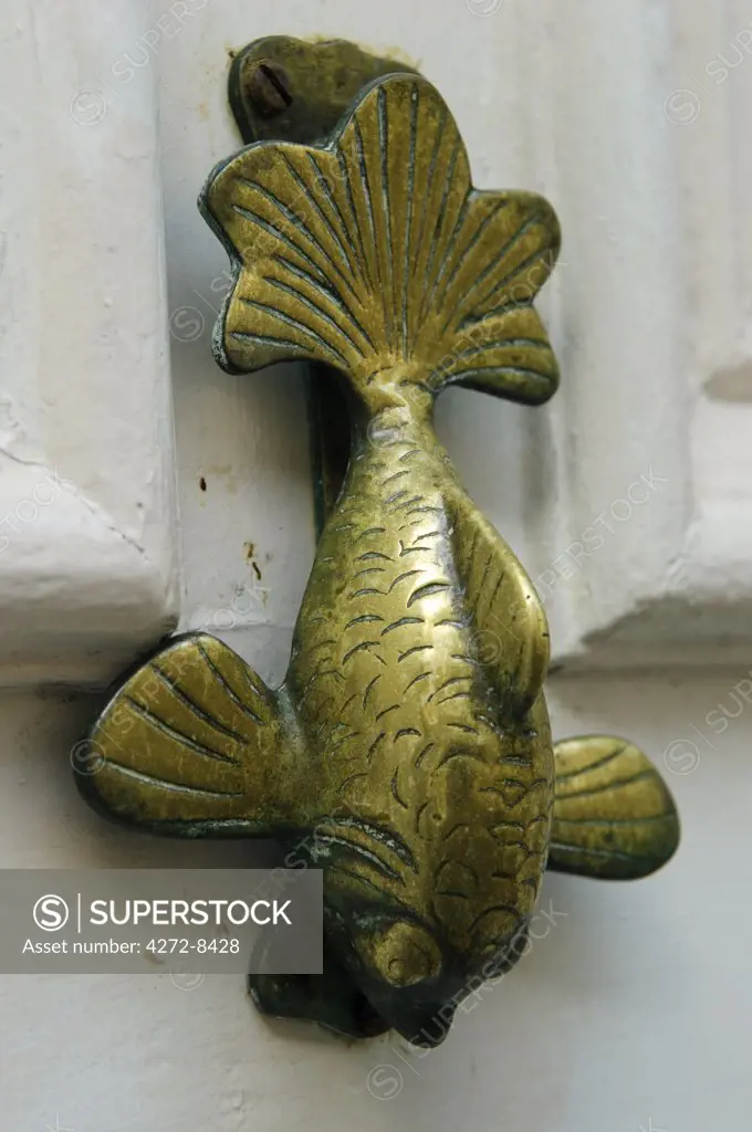 Door knocker in the shape of a fish on a cottage in the Cornish fishing village of Mousehole, Cornwall, England