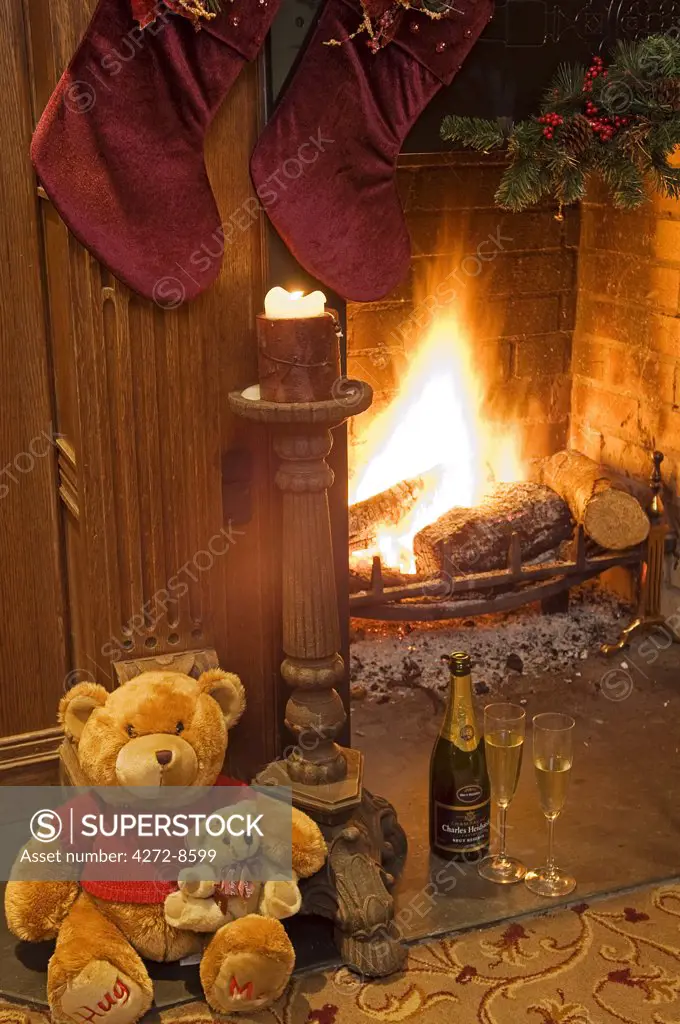 Northern Ireland, Fermanagh, Enniskillen. Champagne by the fire at Christmas at Lough Erne Golf Resort.