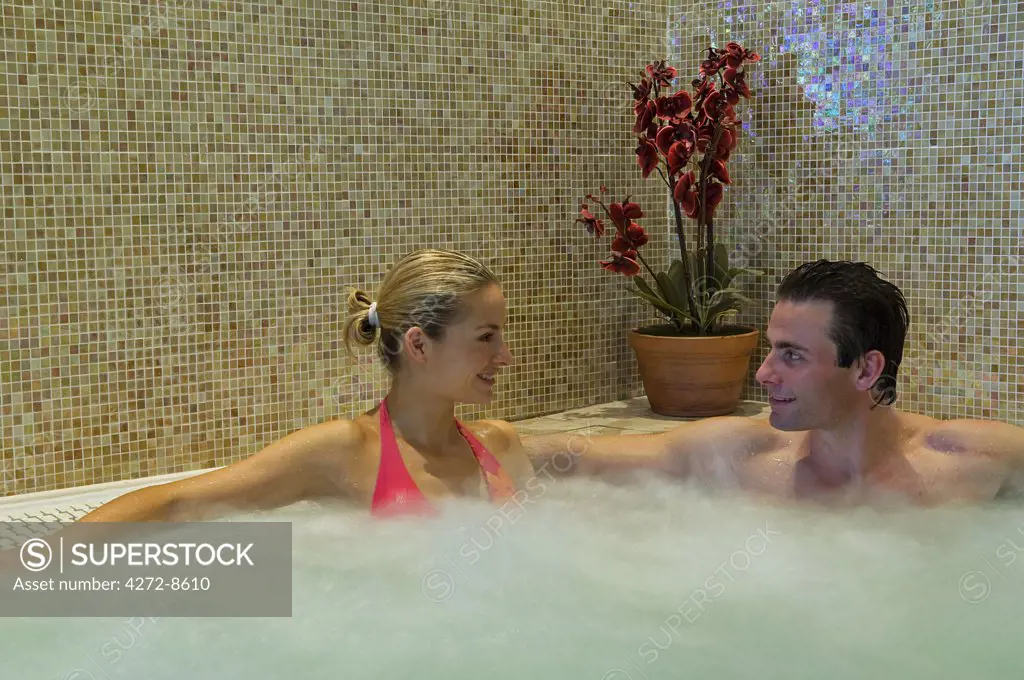 Northern Ireland, Fermanagh, Enniskillen. A couple share a jacuzzi in the Thai spa at Lough Erne Golf Resort (MR).