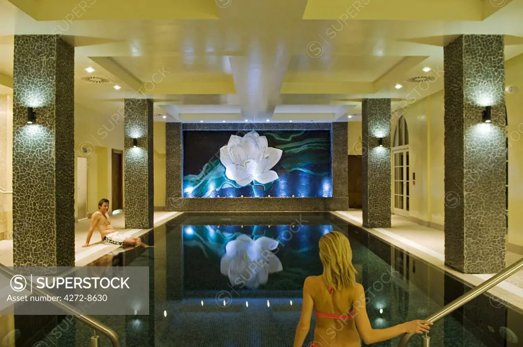 Northern Ireland, Fermanagh, Enniskillen. A couple have a swim in the indoor swimming pool at Lough Erne Golf Resort (MR).