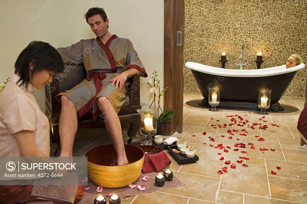 Northern Ireland, Fermanagh, Enniskillen. A couple relax with a Thai foot massage and a hot saok in the bath in the Thai spa at Lough Erne Golf Resort (MR).