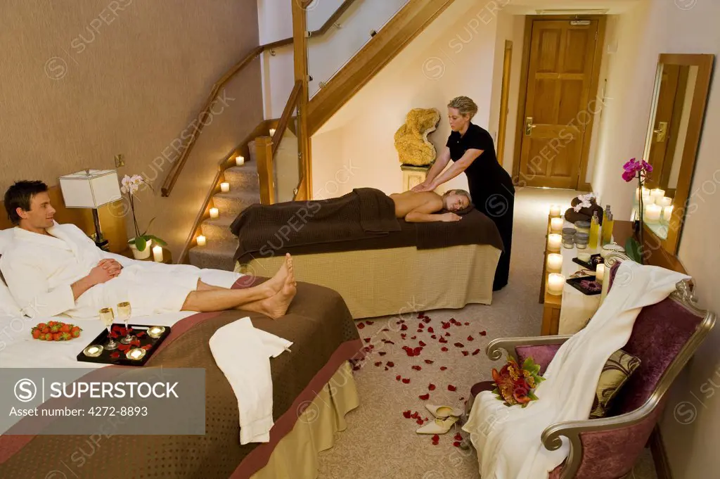 England, Northern Ireland, Belfast. A female guest enjoying a massage in her room at the Culloden Hotel. (MR).