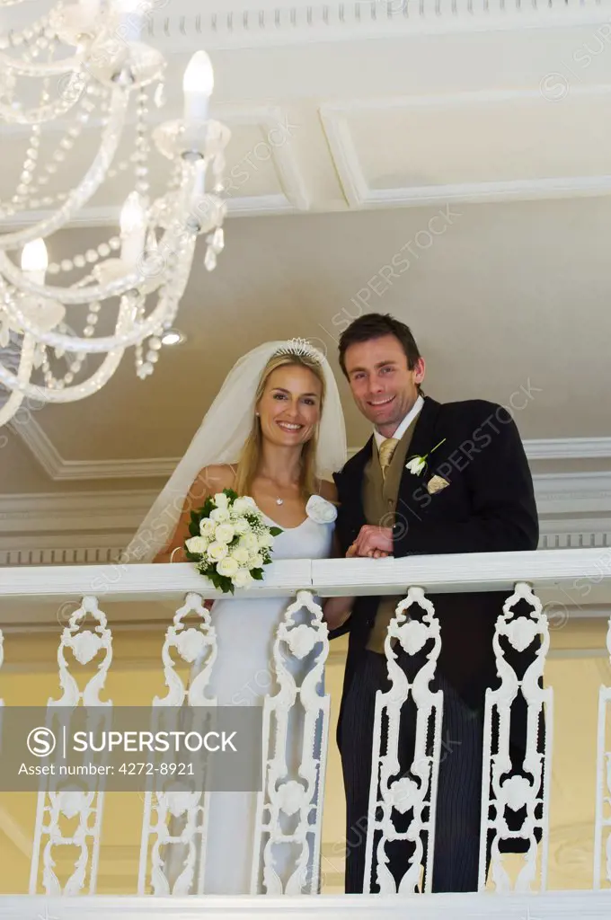 England, Northern Ireland, County Down, Newcastle. A bride and groom on their wedding day at the Slieve Donard Resort and Spa. (MR).