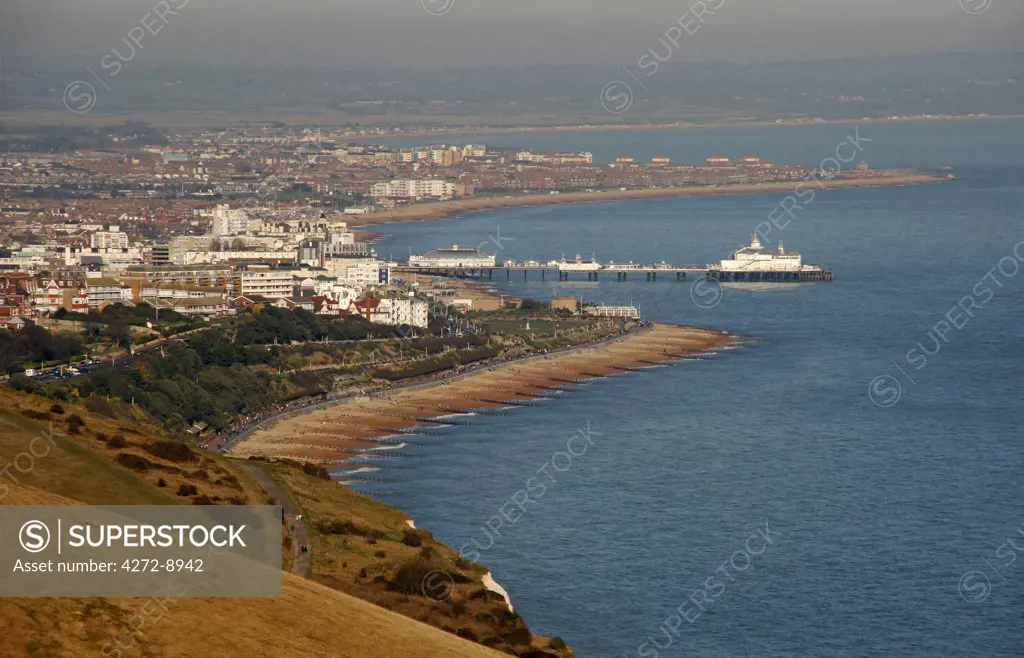 England, East Sussex, Eastbourne. Eastbourne is situated at the eastern end of the South Downs alongside the famous Beachy Head cliff. The sheltered position of the main town behind the cliff contributes to Eastbournes title of sunniest place in Great Britain.