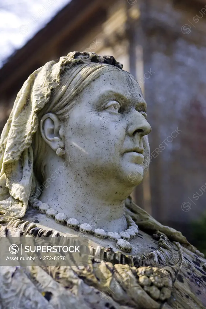 England, Dorset. Athelhampton House - stern faced Queen Victoria overlooks Athelhampton House. It is one of the finest examples of 15th century domestic architecture in the country. Medieval in style predominantly and surrounded by walls, water features and secluded courts.