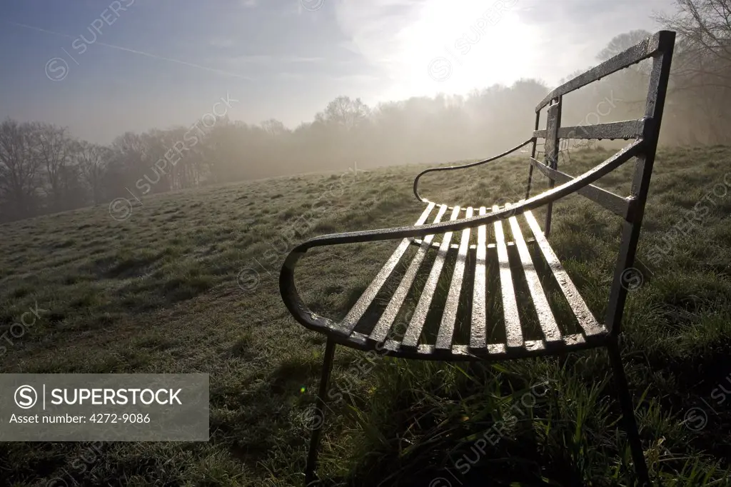 England, Shropshire, Ludlow. Wrought Iron benches on Whitcliffe Common on a misty Spring morning - providing lovely views of the castle and town of Ludlow.