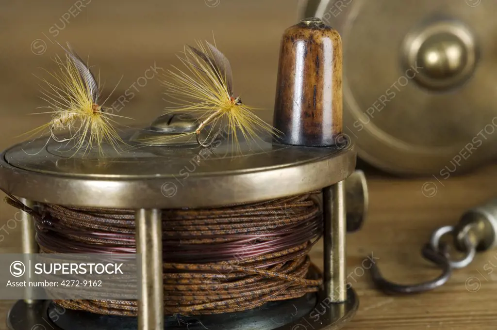 England.  Dry flies on a traditional brass fly fishing reel.