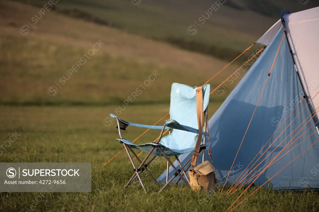 England, Isle of Wight. Tent and camp chair at Compton Farm Campsite, near Brook on the southwest coast.