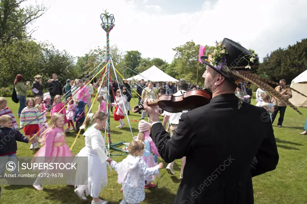 Norfolk, Holt Hall. Children dressed as fairies dance around a maypole at the annual Fairy Fair.