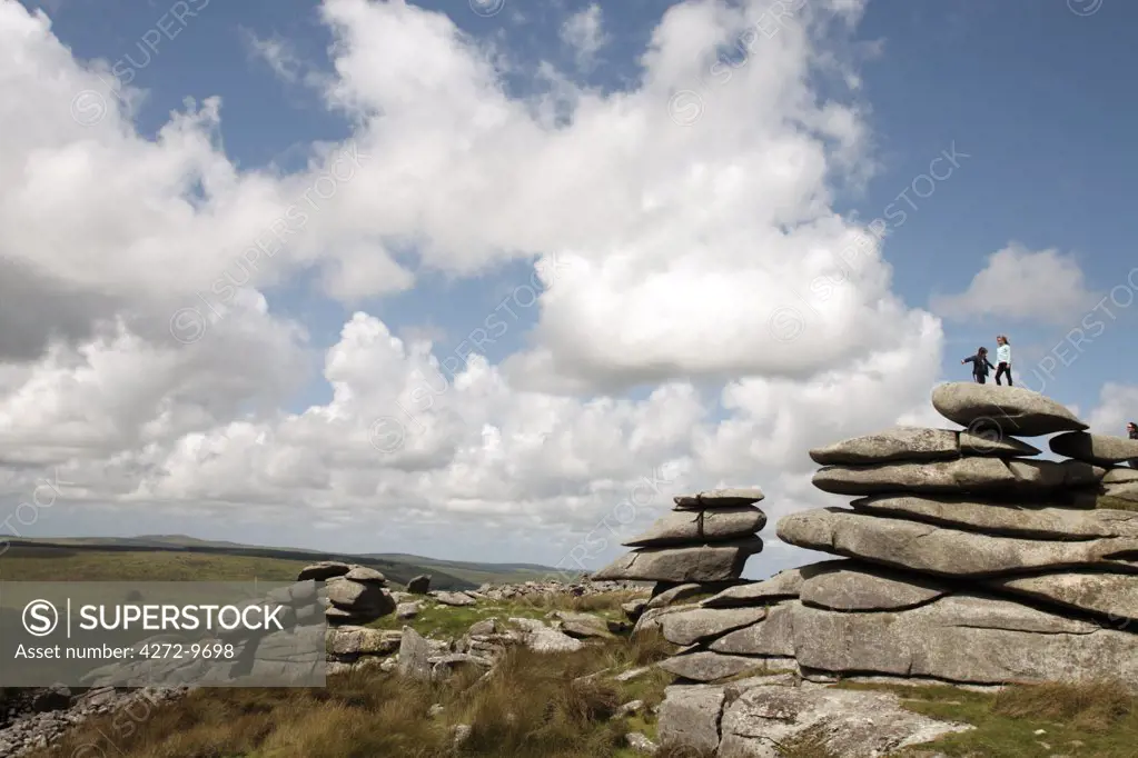 England, Cornwall, Bodmin Moor. Children on top of the Cheesewrings granite tors. (MR)