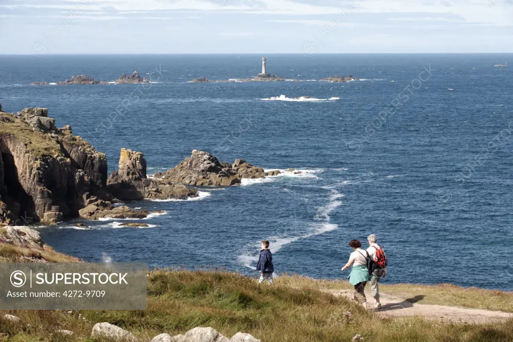 England, Cornwall, Land's End. Family walking on the Coastal Path between Sennen Cove and Land's End