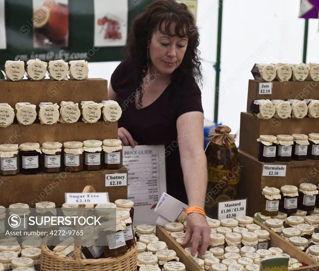 England, Shropshire, Ludlow.  A lady at the Ludlow Food Festival selling jams and chutneys.