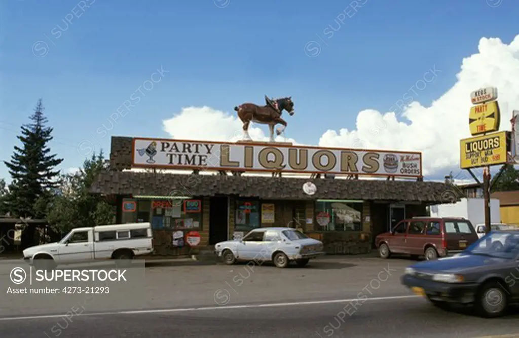 Cars parked in front of Liquors Store with a Horse's Sign, Alaska