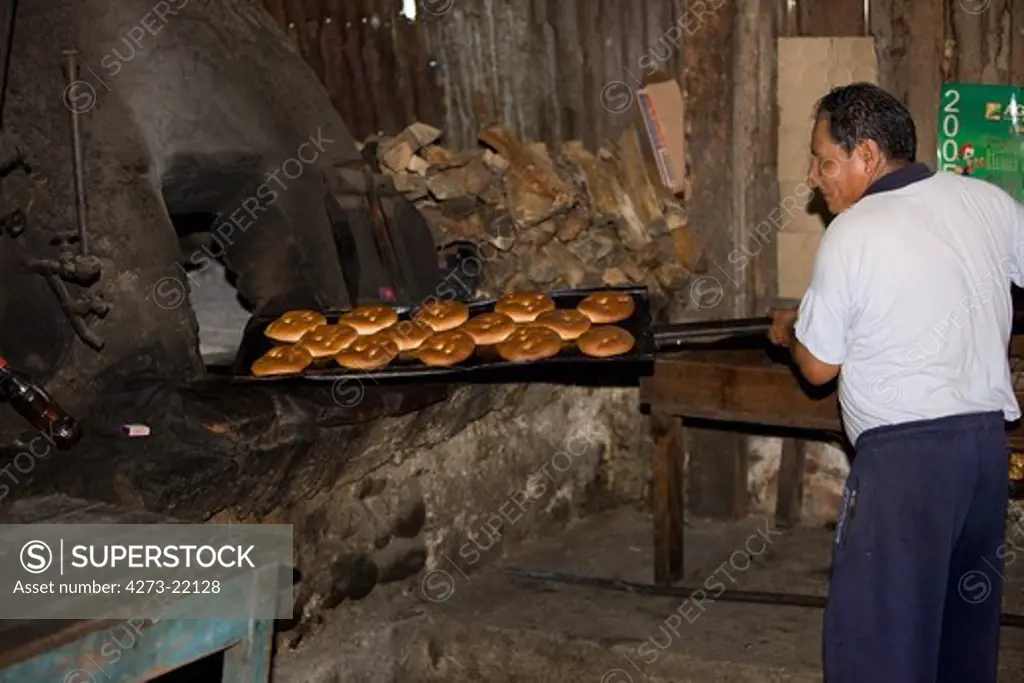 Baker working in Basic Bakery, Pilcopata Village in Peru