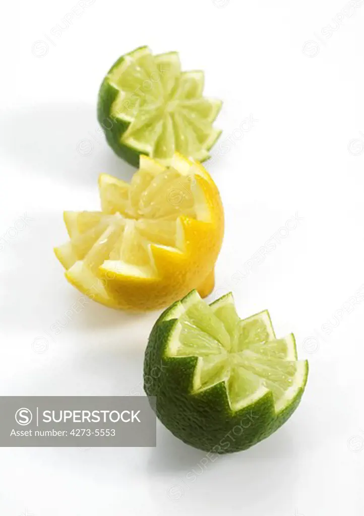 Yellow And Green Lemons Citrus Aurantifolia Against White Background