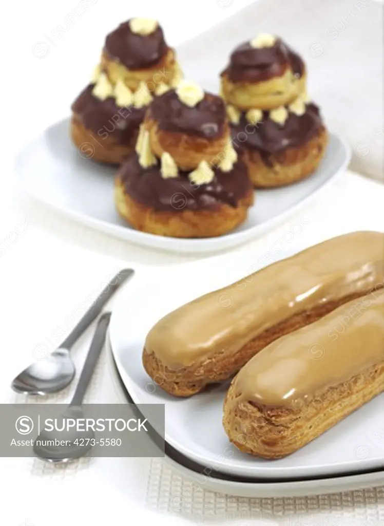 French Cakes Called Chocolate Religieuse And Coffe Eclair