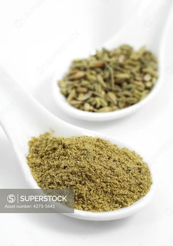 Powder And Fennel Seeds Foeniculum Vulgare Against White Background