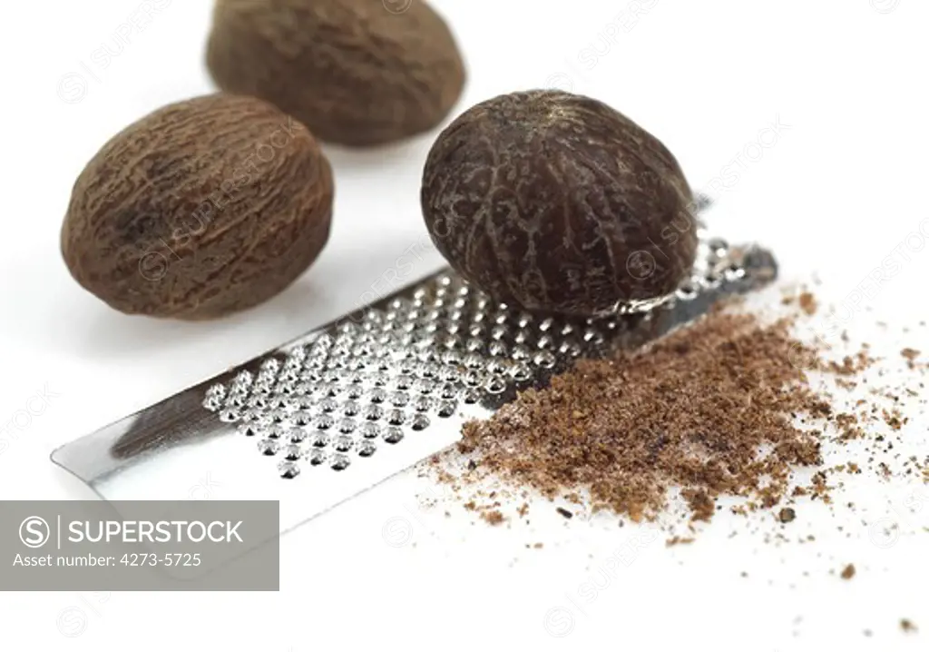 Nutmegs, Myristica Fragrans, Fruit And Grater Against White Background