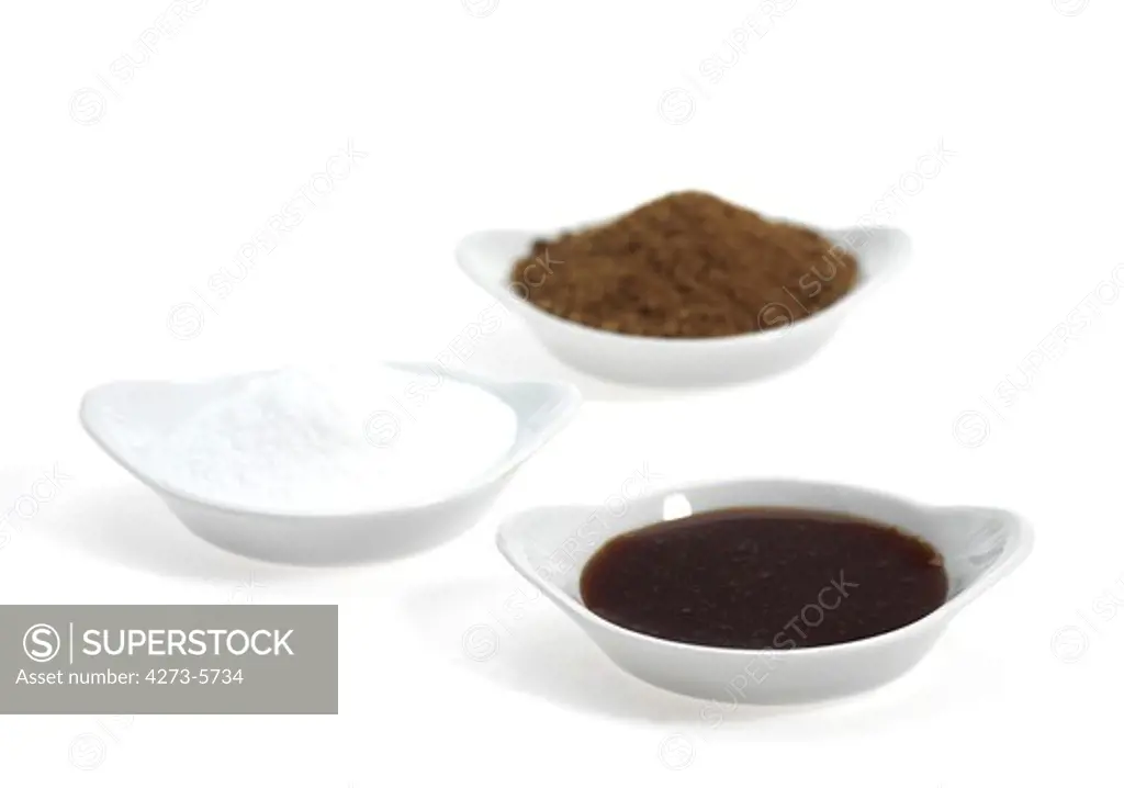 Molasses, White Sugar And Brown Sugar Against White Background