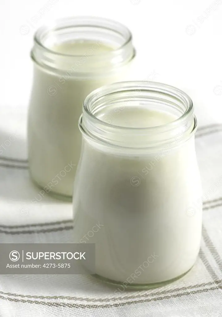 Glasses Of Natural Yoghurt Against White Background