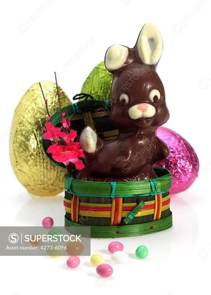 Chocolate Easter Rabbit And Eggs Against White Background