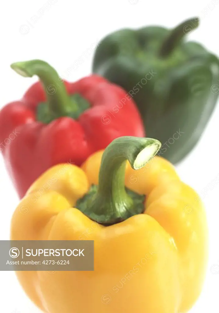 Red Yellow And Green Sweet Pepper, Capsicum Annuum, Against White Background