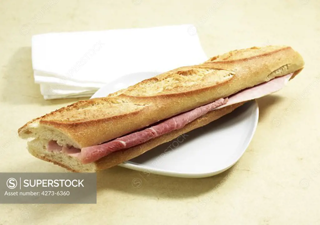 Sandwich With Ham And Butter In A Plate
