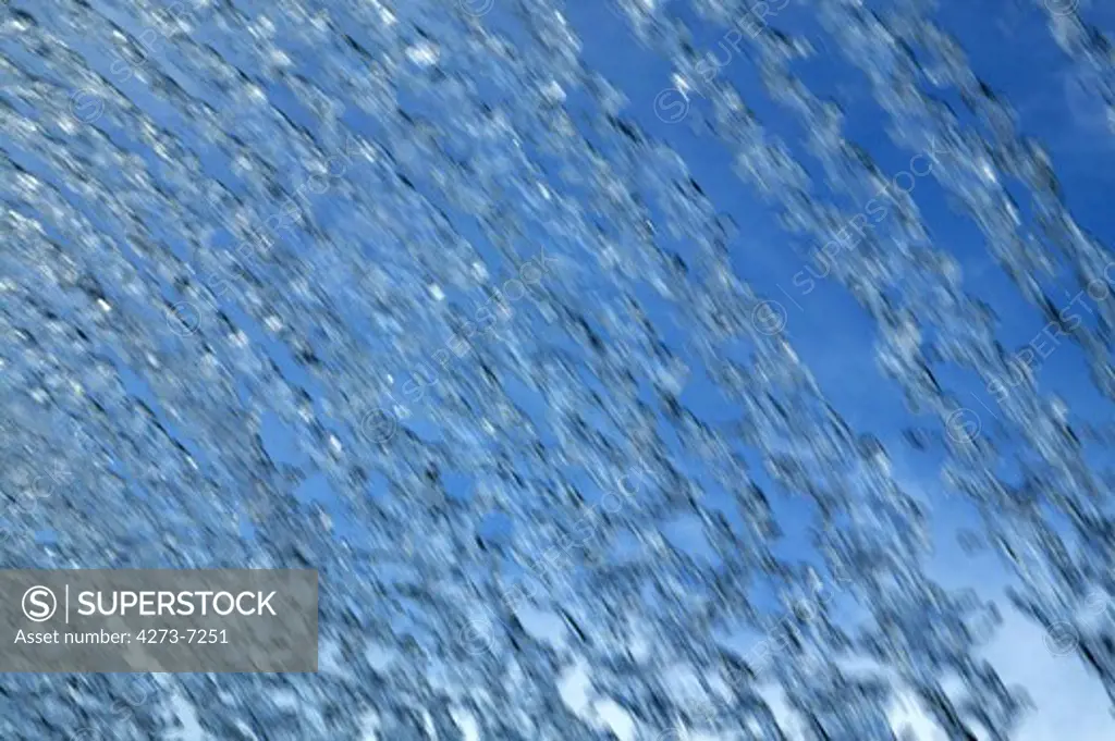 Foutain With Water Jets Against Blue Sky