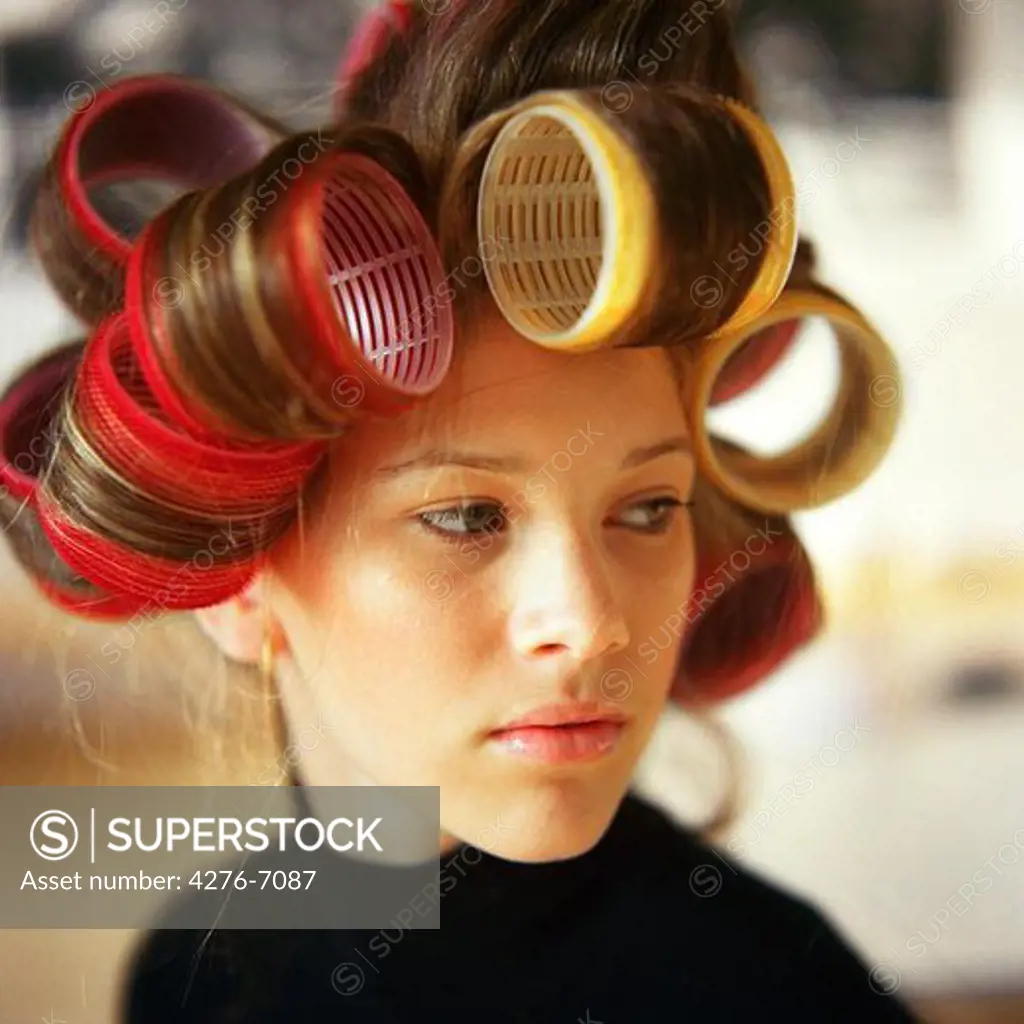 Young woman with rollers in hair