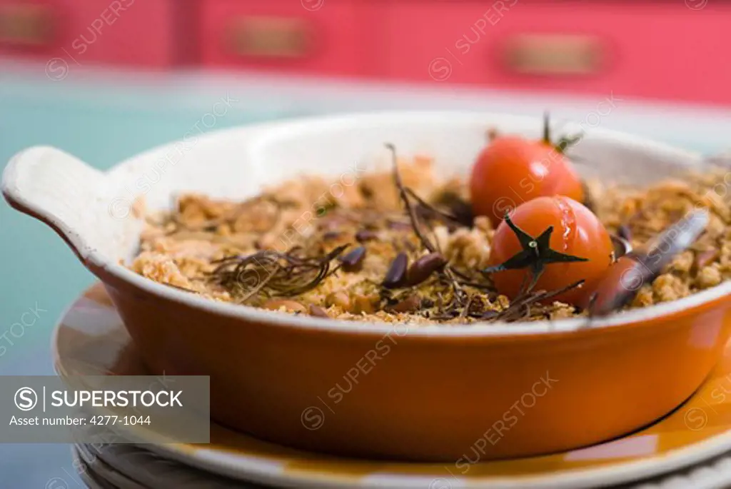 Tomato and herb crumble in baking dish