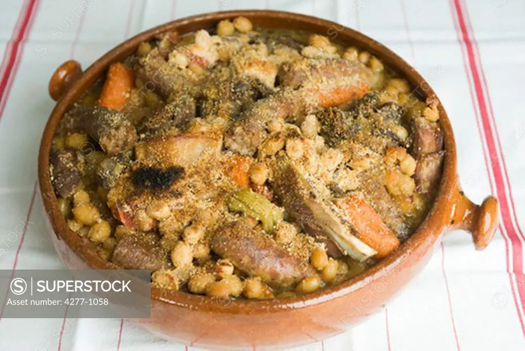 Cassoulet with fresh beans in earthenware serving dish