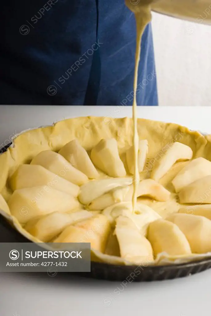 Pouring filling into crust for pear tart