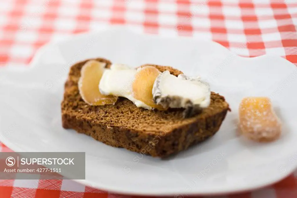 Sliced gingerbread with goat cheese and candied ginger