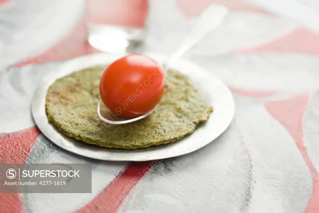Savory spiced crepes topped with cherry tomato