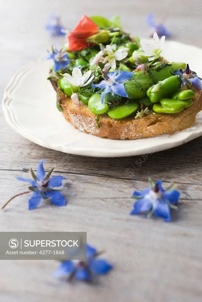 Broad bean and herb tartines with wildflowers