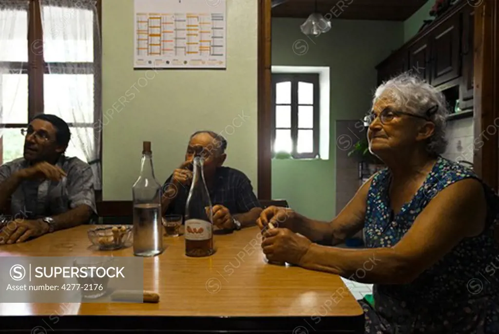 Seniors sitting around table having drinks