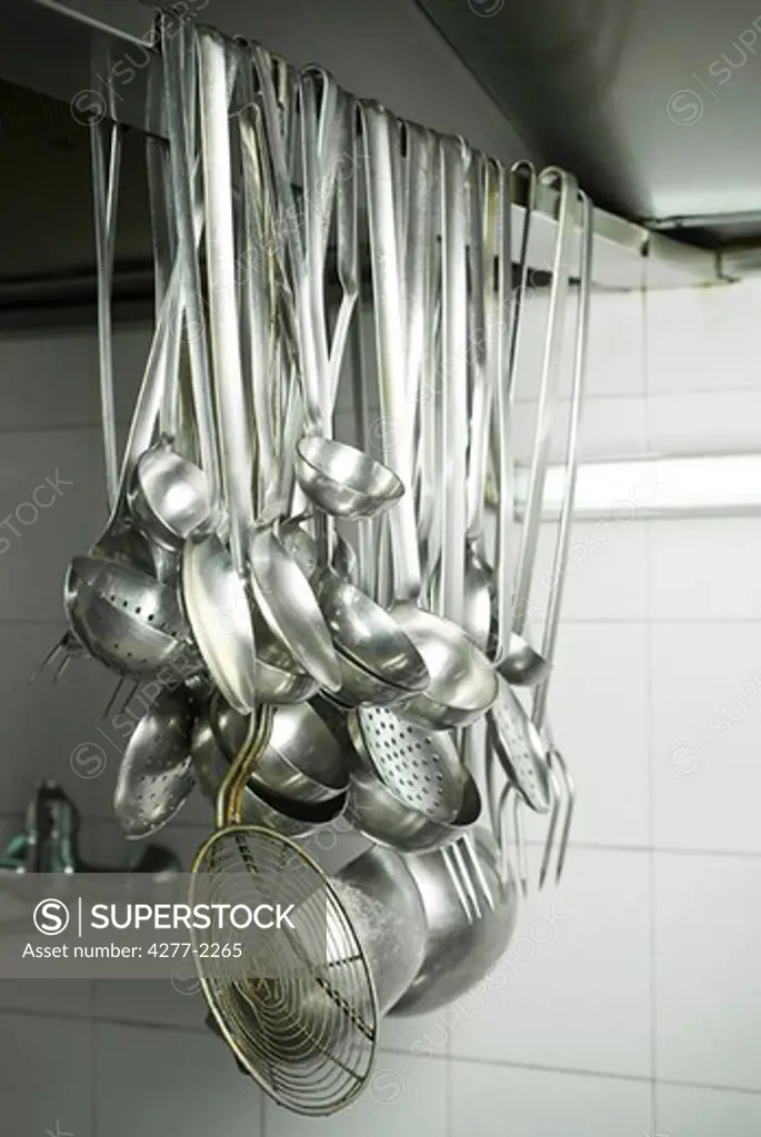 Cooking utensils hanging in kitchen