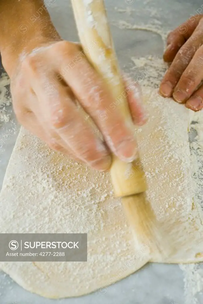 Making lasagna noodles, dusting pasta dough with flour