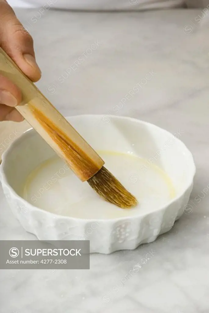Greasing baking dish with pastry brush