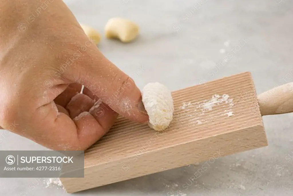 Making fresh gnocchi using gnocchi board
