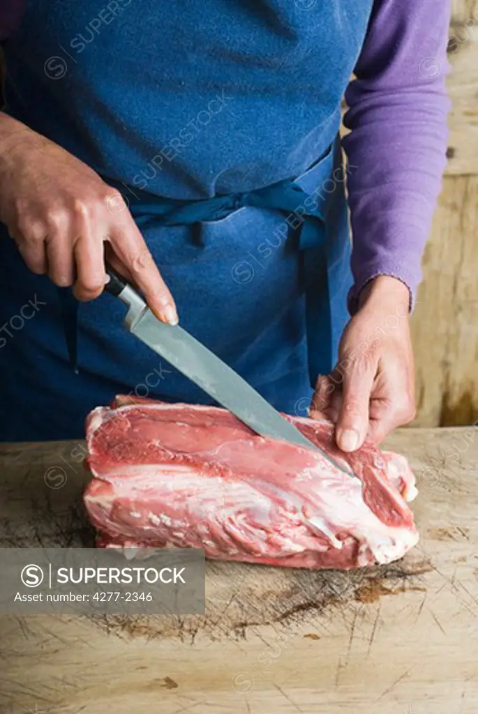 Slicing meat off duck carcass