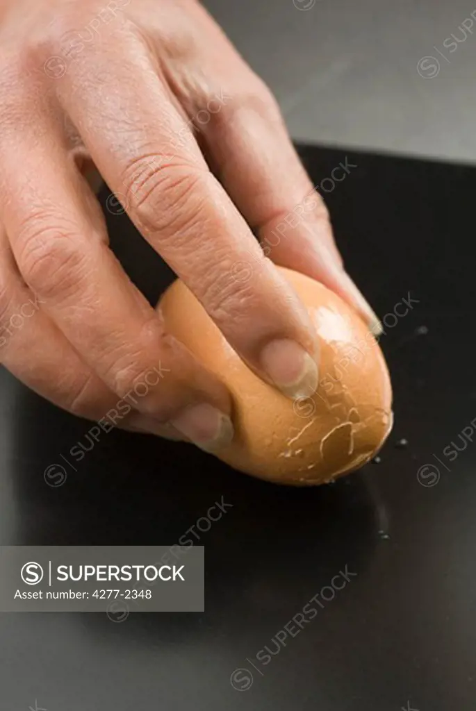 Cracking hard-boiled egg