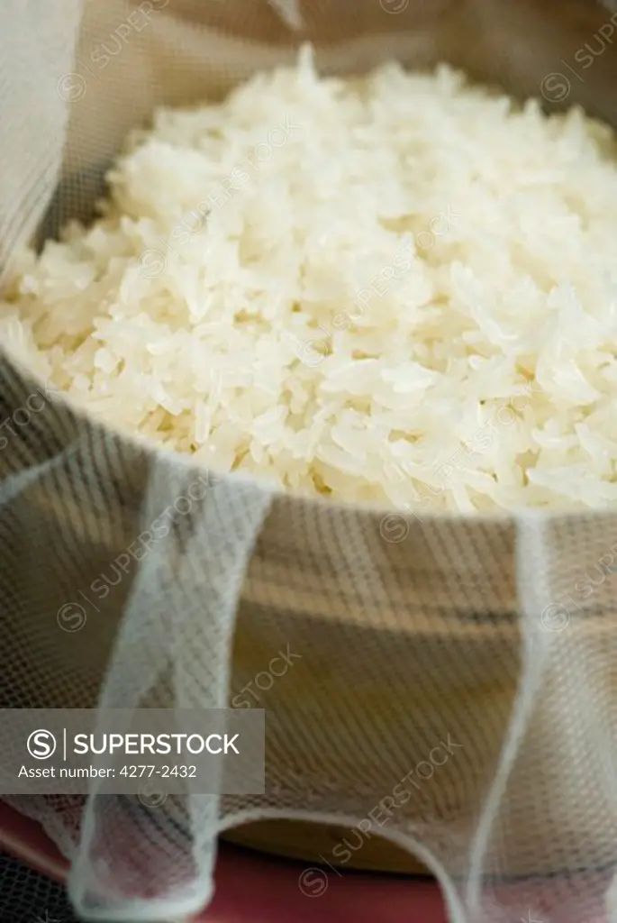 Preparing sticky rice in steamer