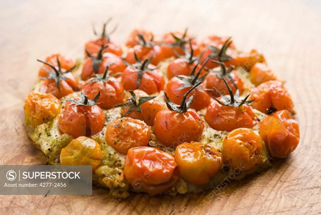 Pizza with cherry tomatoes, pesto and ricotta