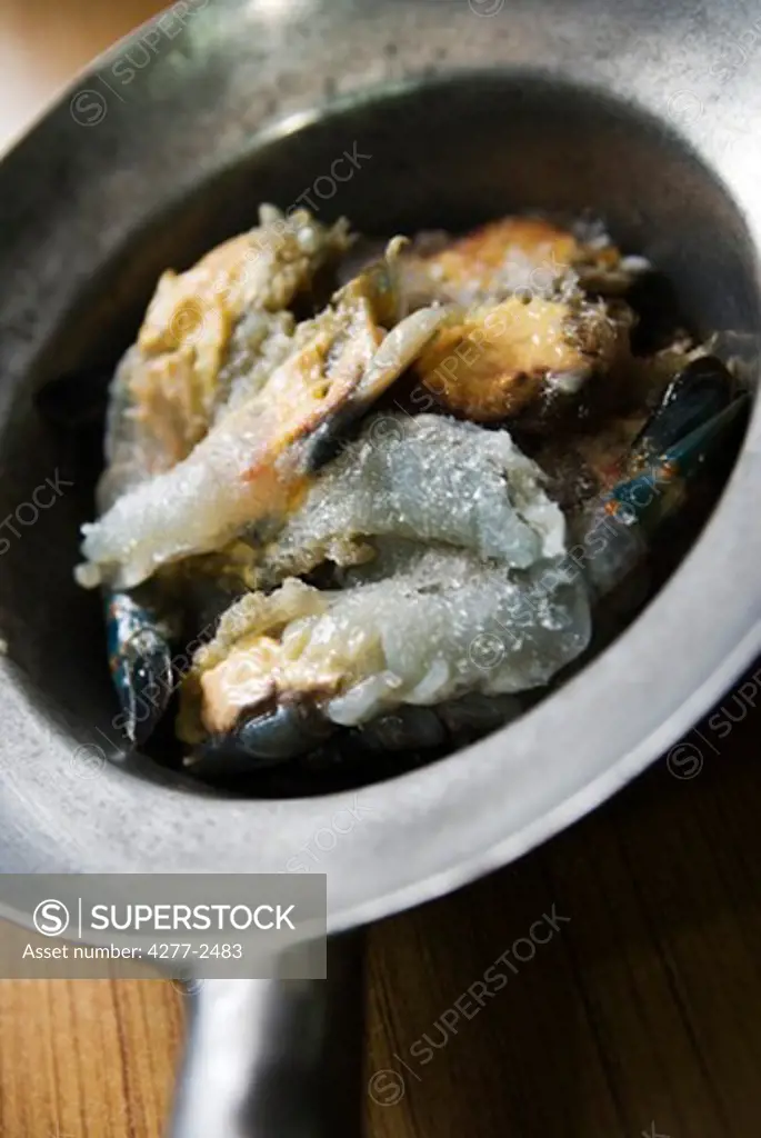 Raw frozen shrimp in pan