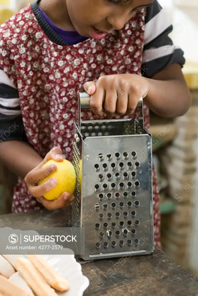 Girl zesting a lemon