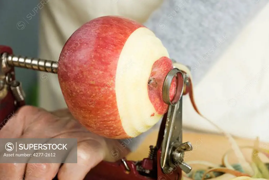 Peeling apple with apple peeler