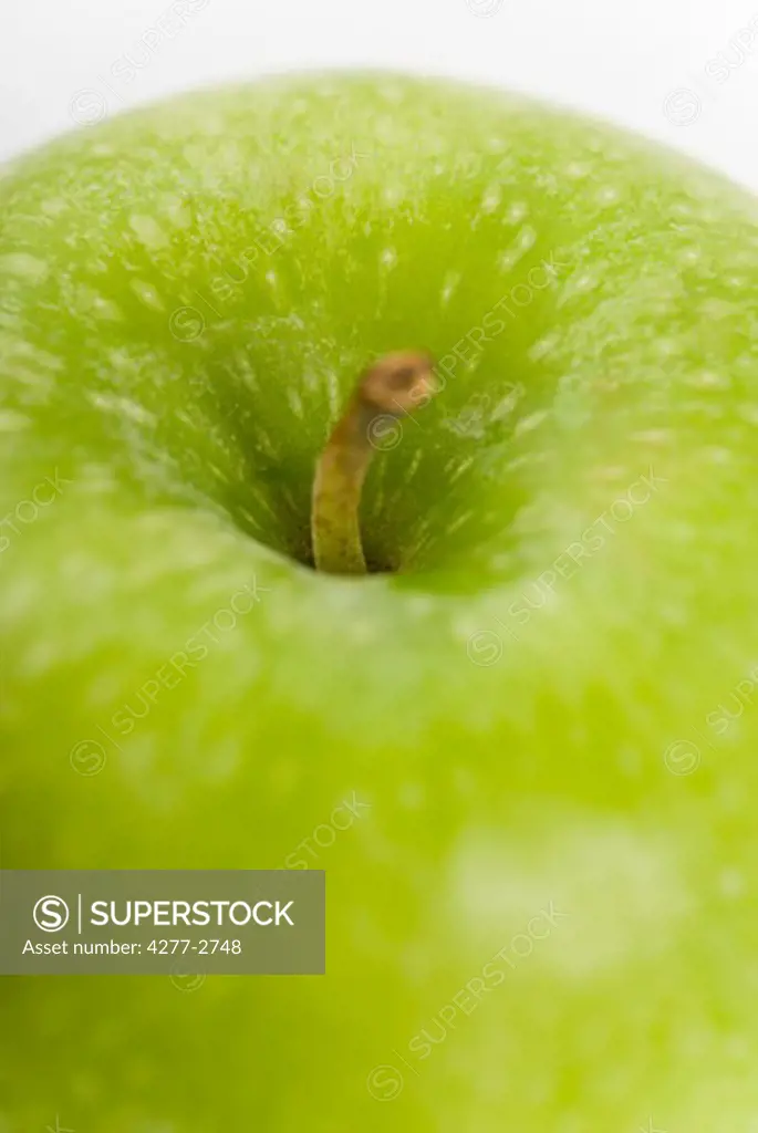Green apple, close-up of stem