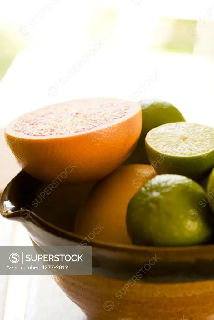 Sliced grapefruit, limes
