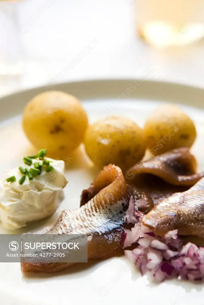 New potatoes with pickled herring and sour cream